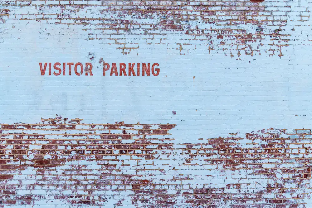 Close up of painted brickwork with weathered lettering