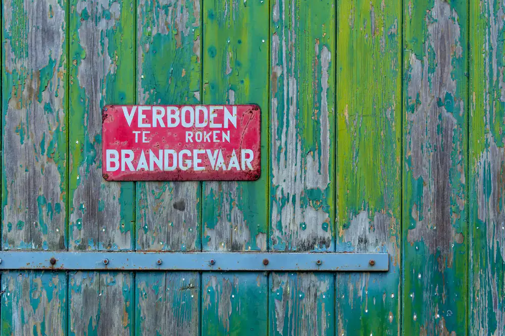 Hand-painting a wooden sign panel