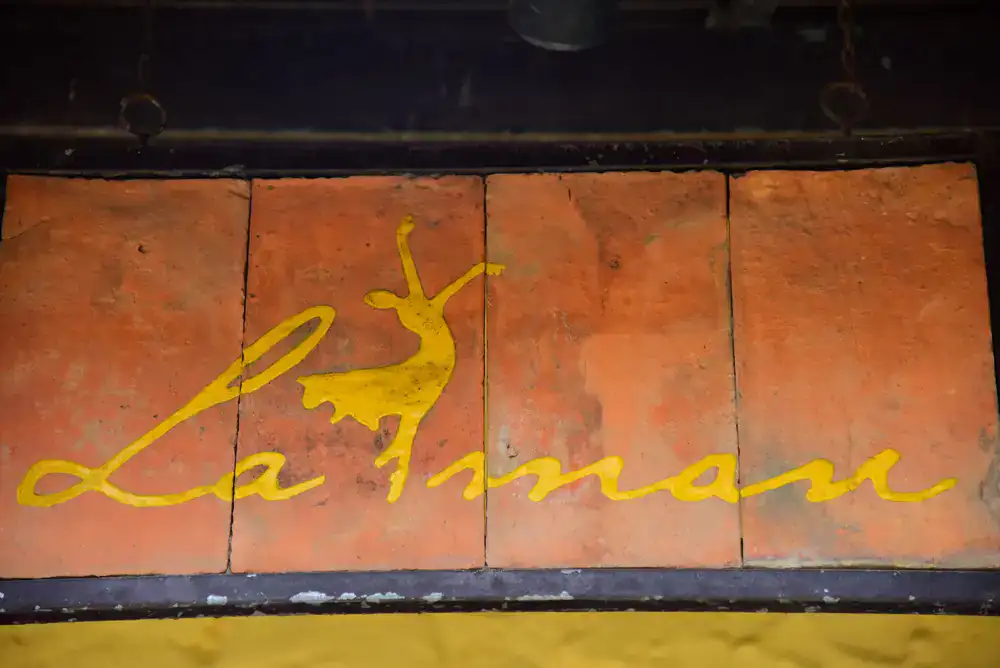 Carefully restored hand-painted ghost sign on brick